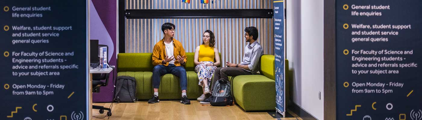 Three students sitting and talking in the student support hub